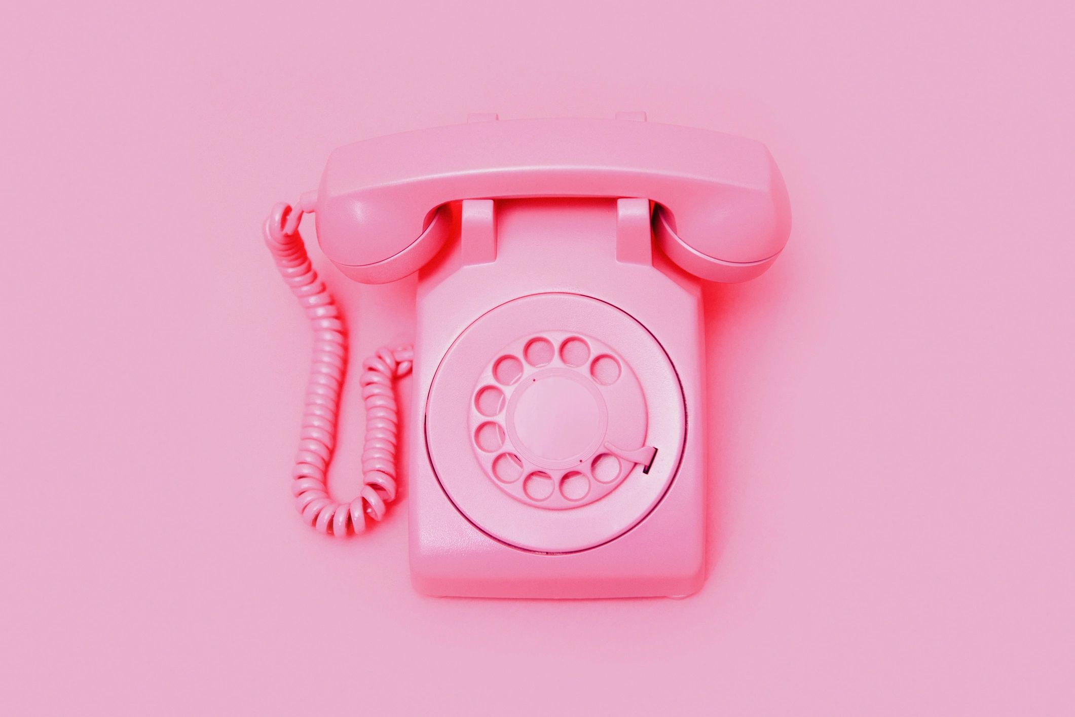 Retro pink telephone on a pink background