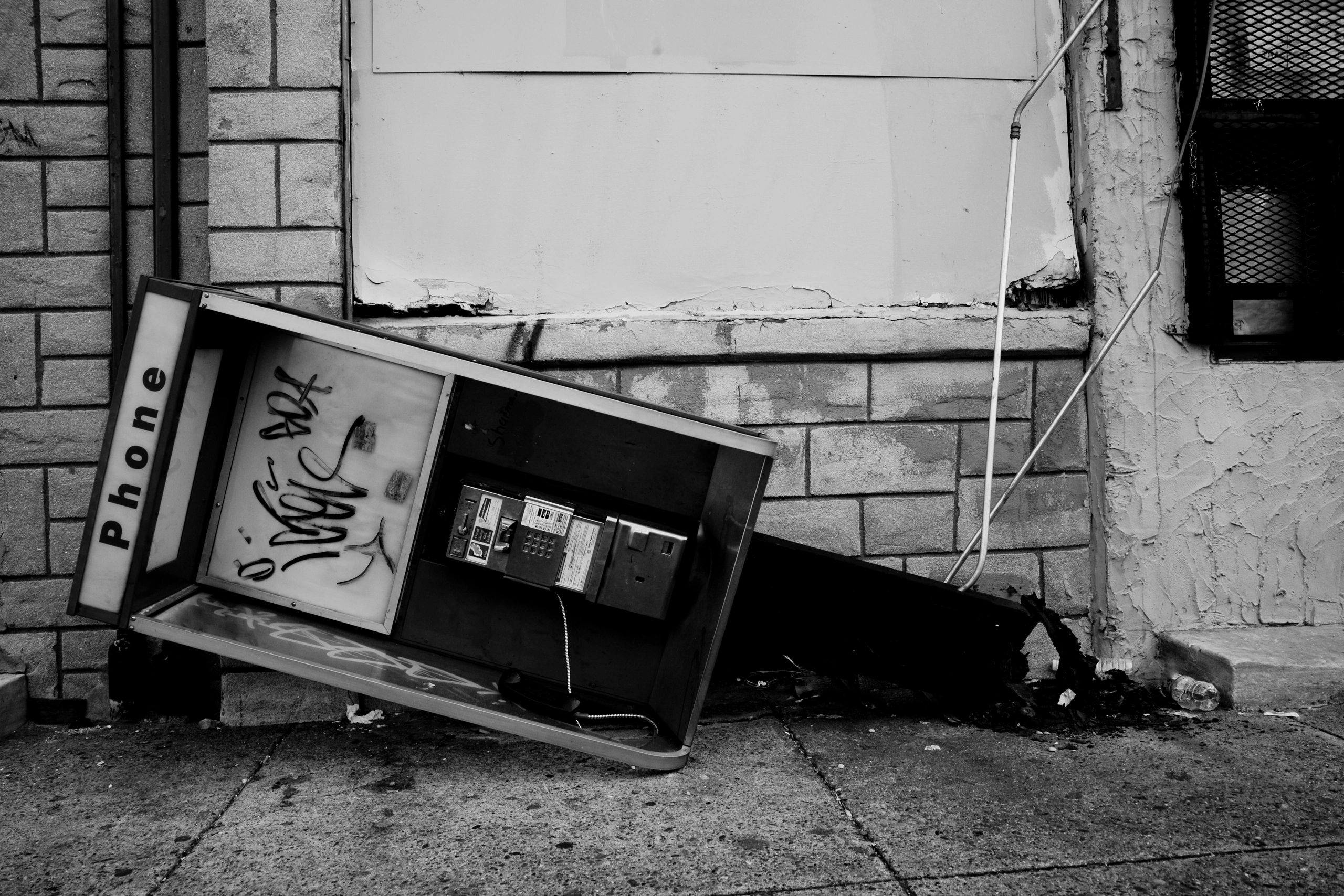 Broken phone booth on its side