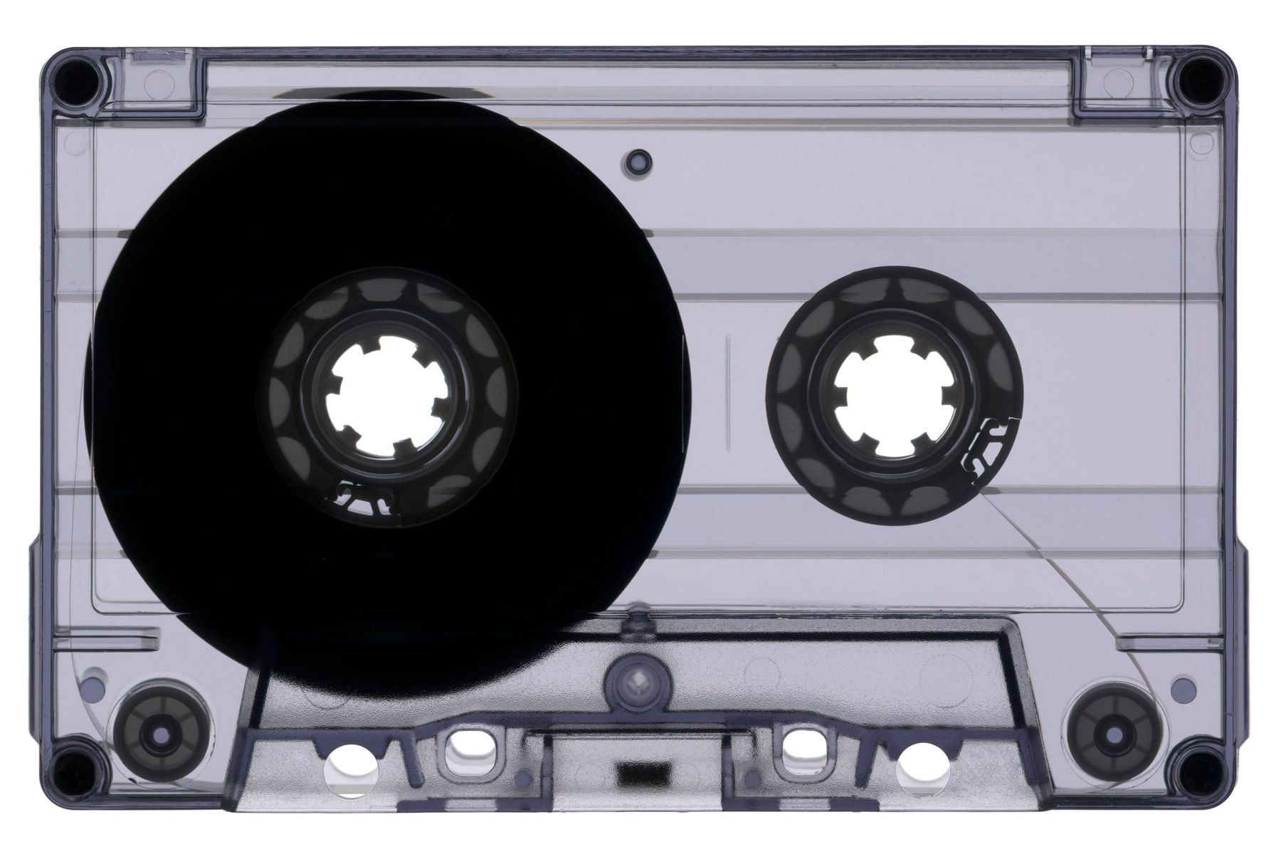 Transparent audio cassette tape on white background